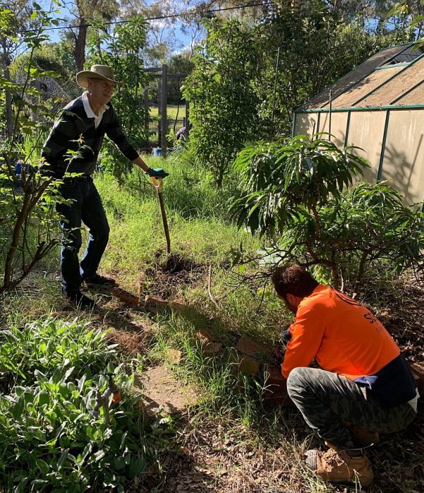 Gardening Bee March 2021 - CRS volunteers working in refugee family garden